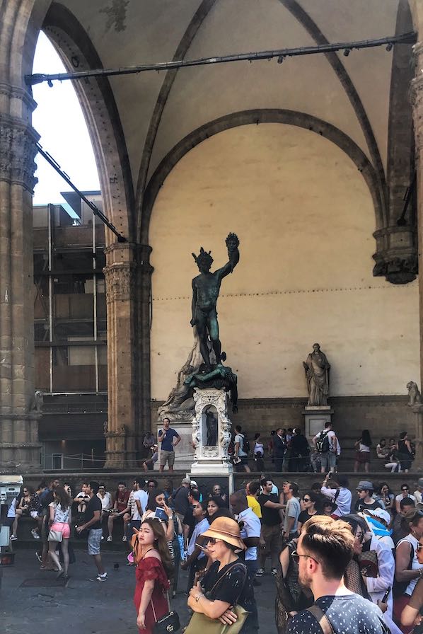 statue of perseus with crowd around