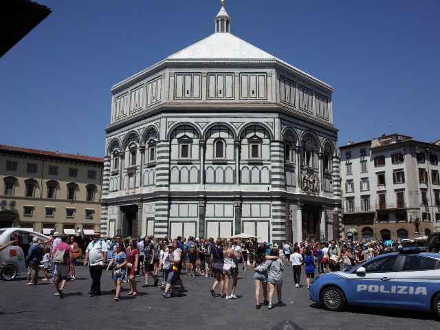 summer crowds of people outside the florence baptistery